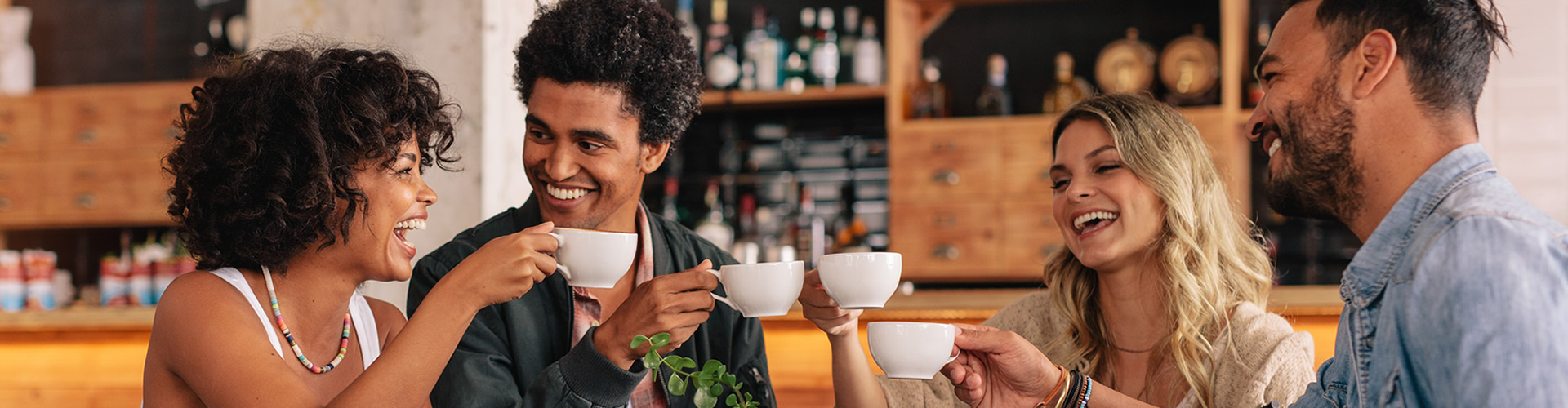 group of friends laughing and having coffee together